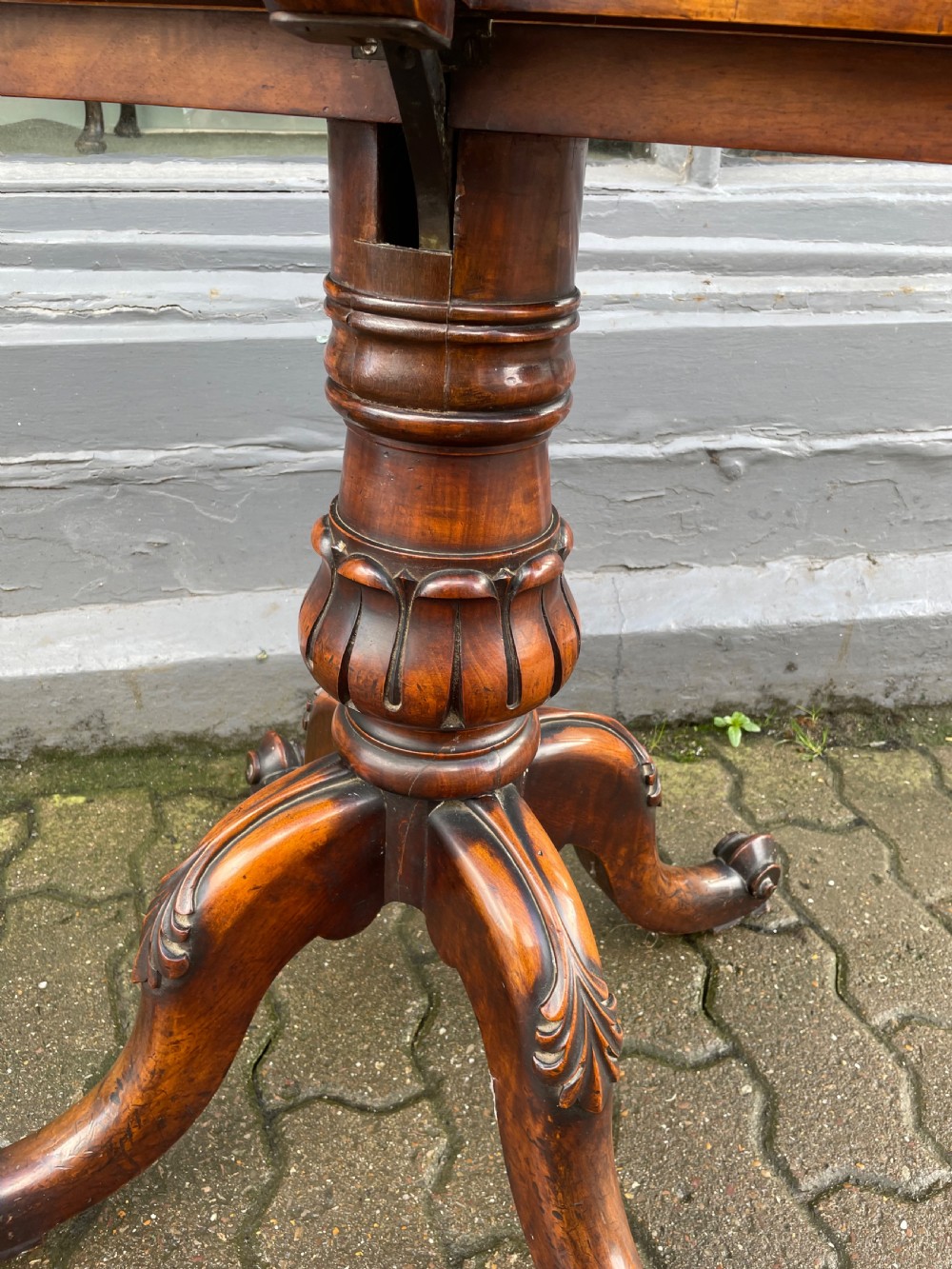 An antique wooden folio stand featuring a slatted double-sided display frame mounted on a carved pillar and tripod base. View III