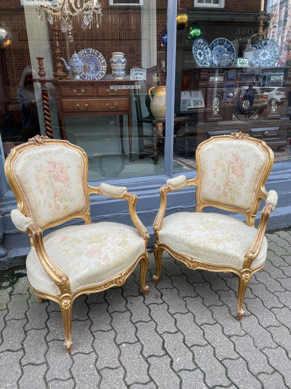 An Antique pair of giltwood elbow chairs
