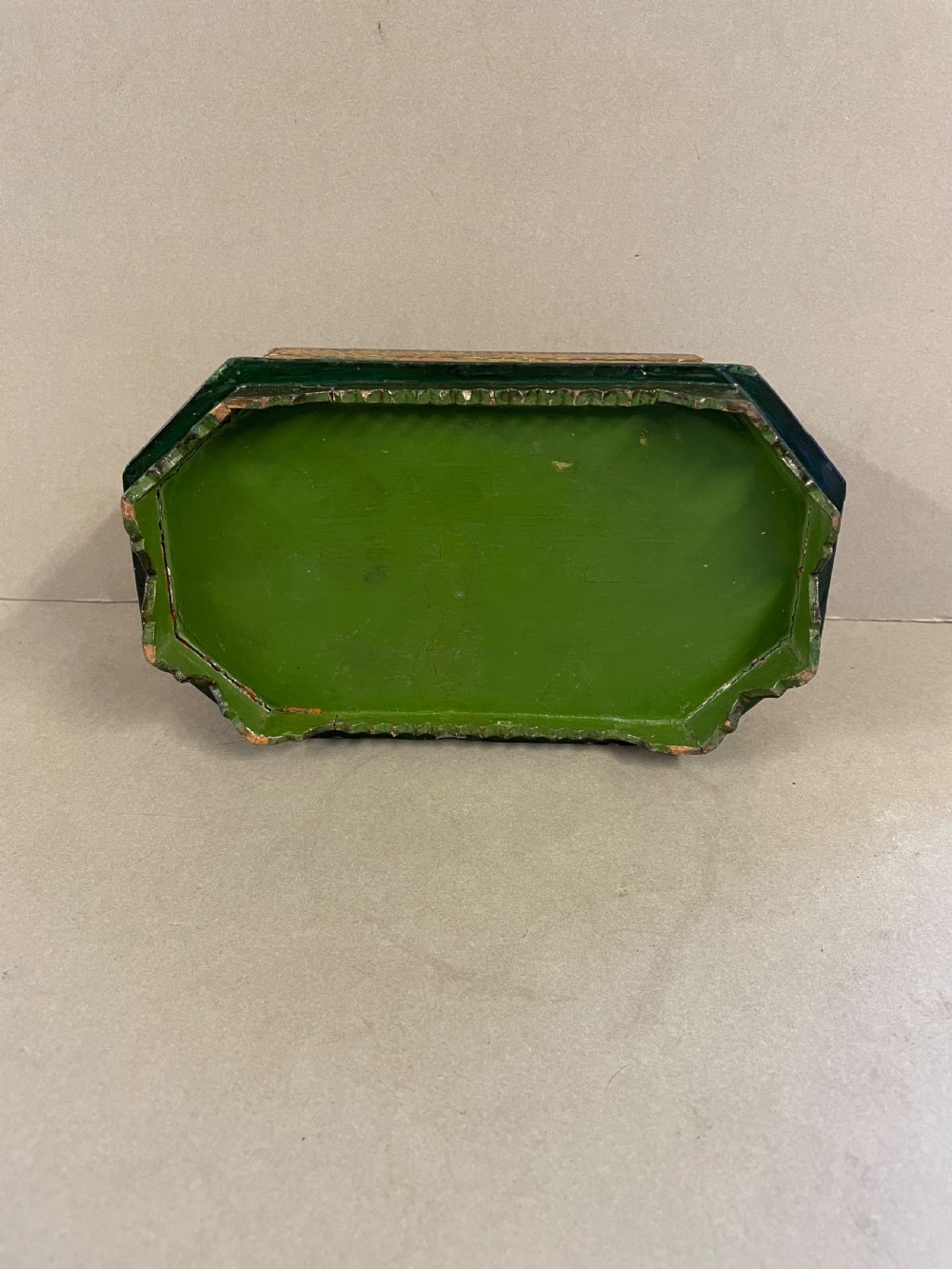 An antique octagonal papier-mache casket featuring intricate hand-painted floral and paisley patterns in green, gold, orange, and black tones. View VI