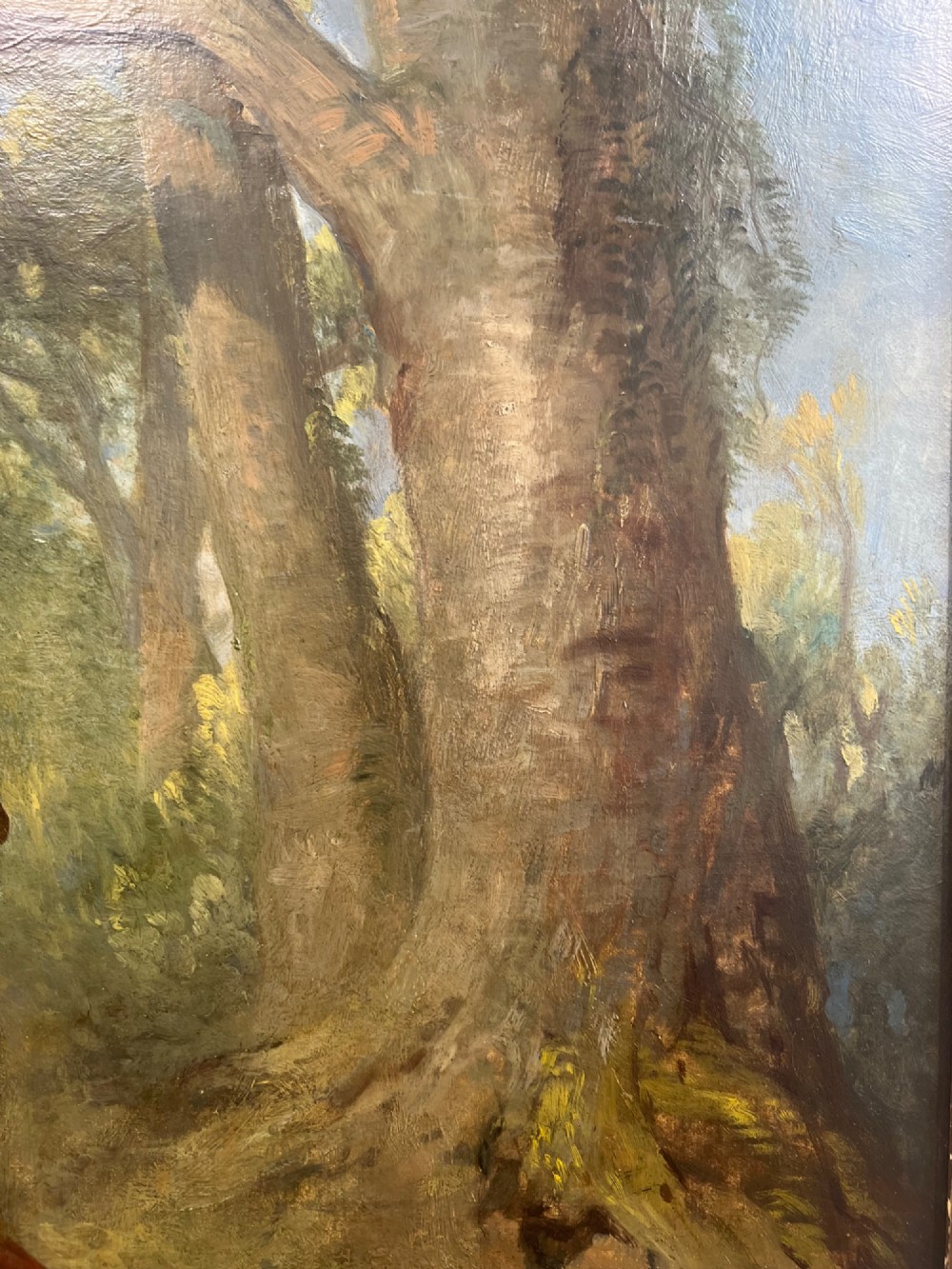 An antique oil painting depicting three young children posed outdoors near a large tree within a molded wooden frame. View IV