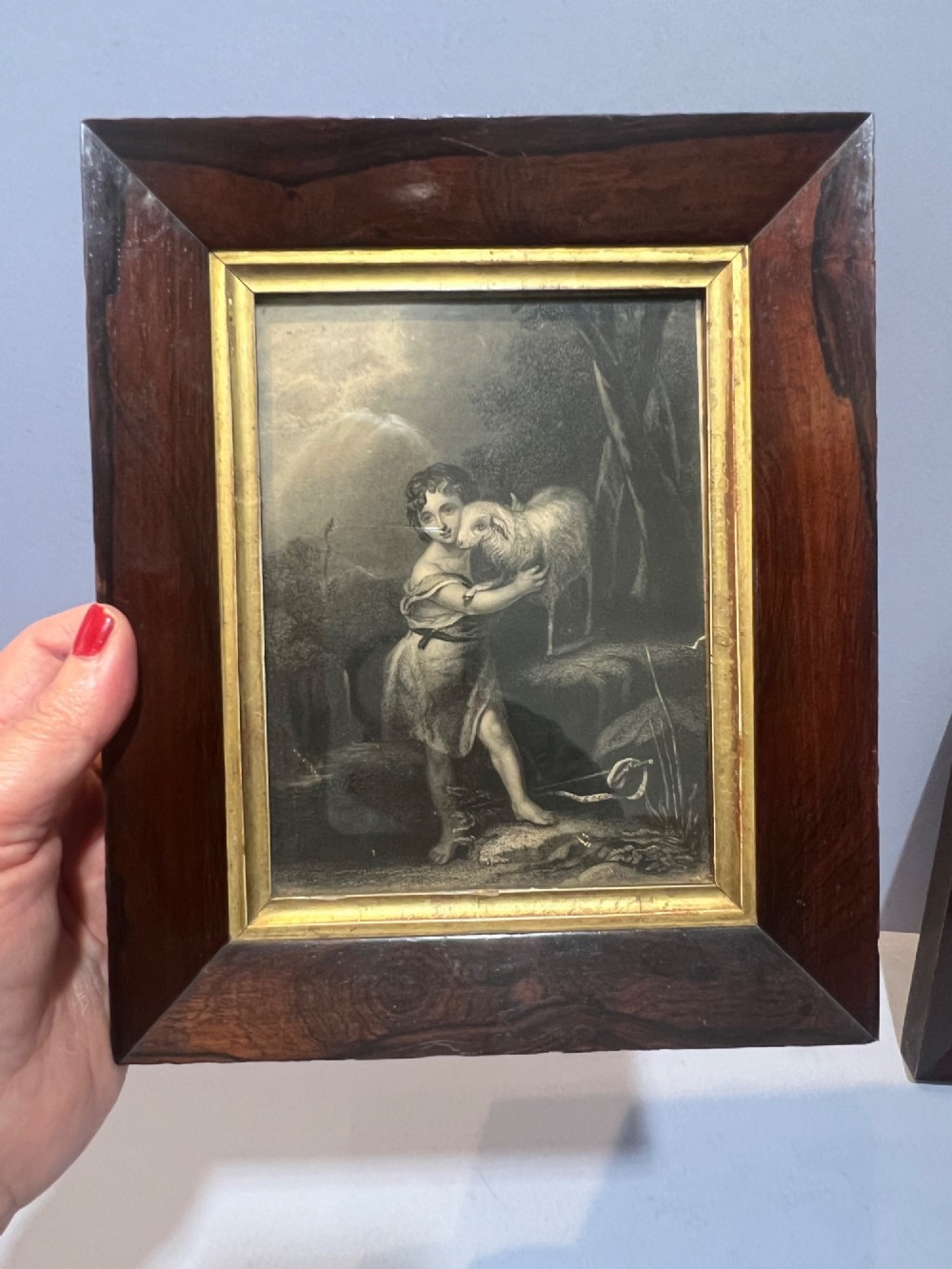A pair of small framed antique engravings featuring religious figures set within wide dark rosewood frames with inner gilt slips. View II