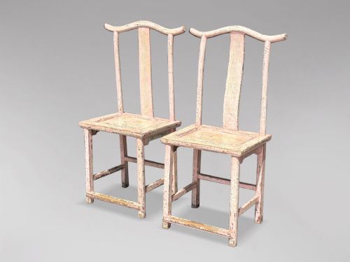fig 1. A pair of 19th-century Chinese yoke-back side chairs featuring a distressed pale pink painted finish, curved top rails, and central vertical back splats.