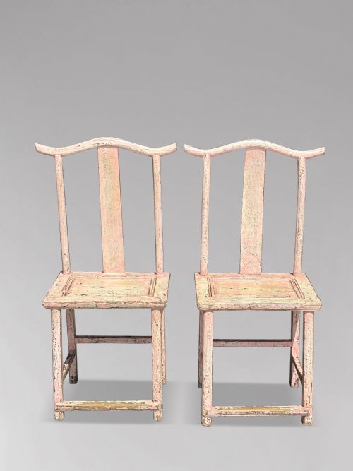 fig 2. A pair of 19th-century Chinese yoke-back side chairs featuring a distressed pale pink painted finish, curved top rails, and central vertical back splats.