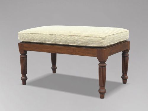 fig 1. A 19th-century rectangular teak stool with fluted turned legs and a cream textured upholstered cushion top.