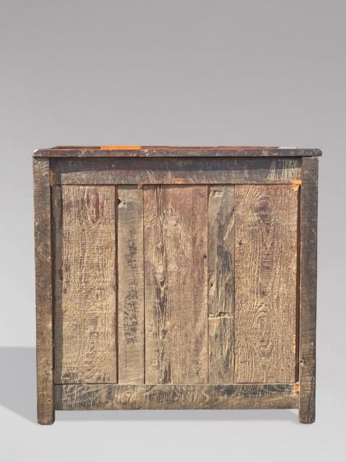 fig 4. A 17th-century French Provincial walnut commode featuring three long drawers decorated with brass drop handles and central escutcheons.