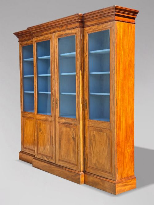 fig 1. A 19th-century French Louis Philippe walnut four-door bookcase featuring glazed upper doors, panelled lower sections, and a blue painted interior.