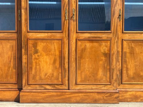 fig 3. A 19th-century French Louis Philippe walnut four-door bookcase featuring glazed upper doors, panelled lower sections, and a blue painted interior.