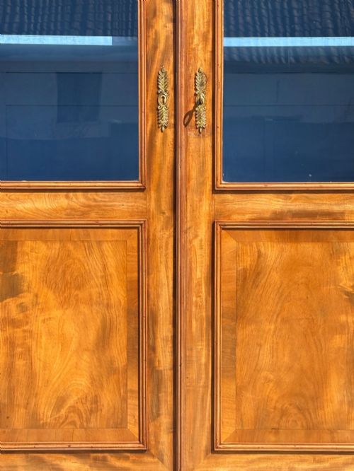 fig 4. A 19th-century French Louis Philippe walnut four-door bookcase featuring glazed upper doors, panelled lower sections, and a blue painted interior.