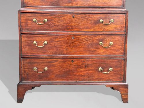 fig 2. An 18th-century George III mahogany chest on chest featuring upper and lower drawer sections with brass handles and bracket feet.