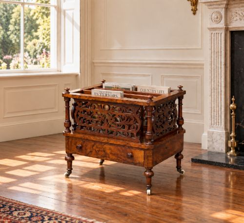 fig 1. A mid-19th-century Victorian walnut music canterbury featuring open fretwork dividers, turned corner columns, a single base drawer, and turned legs with ceramic castors.
