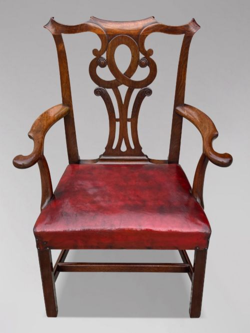 fig 1. An 18th-century George III mahogany Chippendale armchair featuring a carved pierced splat back, curved arms, and a red leather upholstered seat.