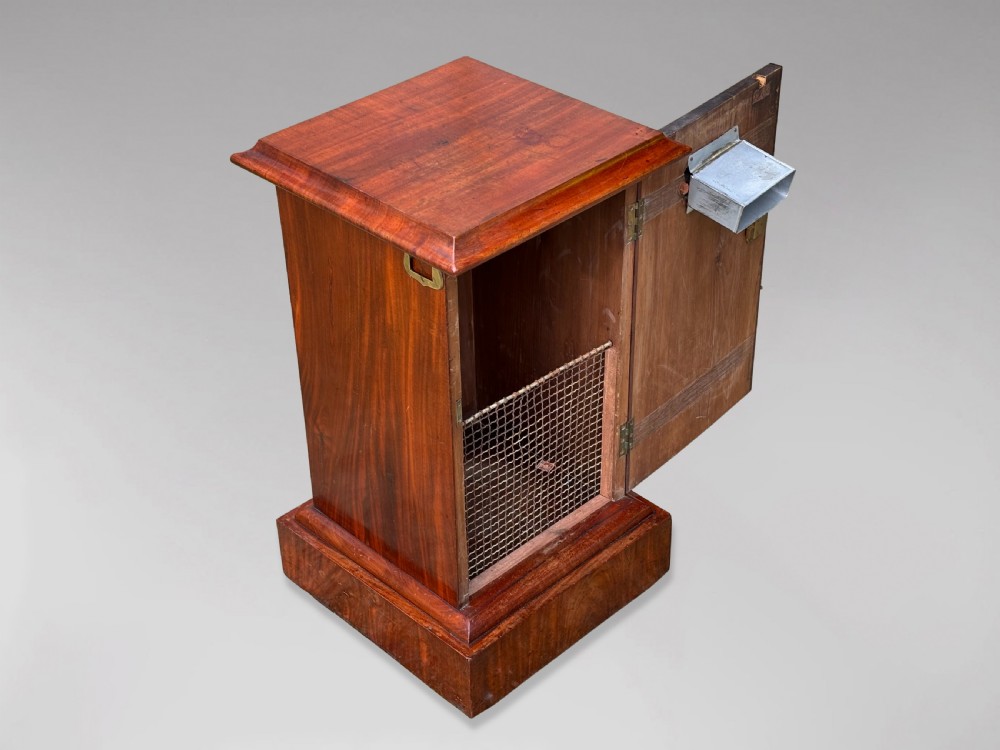 A 19th-century mahogany post box with a molded lid, brass letter slot, collection times plaque frame, and front key lock. View IV