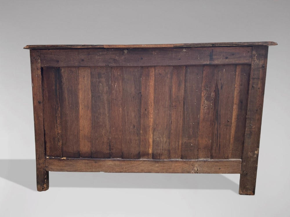 An 18th-century French Provincial walnut commode with three moulded drawers and decorative brass handles. View VII