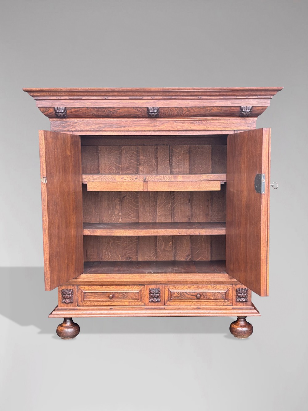 A 19th-century rosewood Renaissance Revival cabinet featuring relief foliage borders, fielded double doors, two lower drawers, and spherical bun feet. View VII