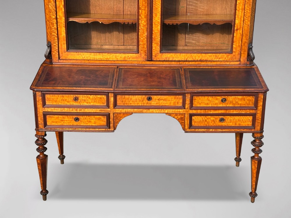 A 19th-century French maple bureau bookcase featuring a top glazed two-door display section above a kneehole writing desk with leather inset panels and turned legs. View III