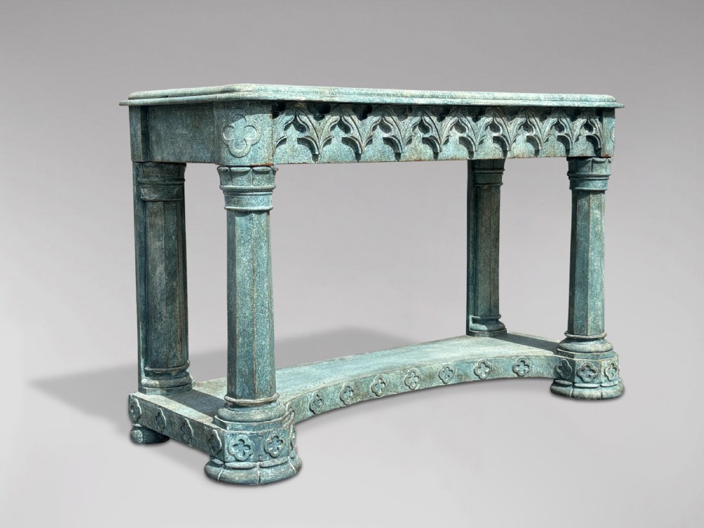 A 19th-century Gothic Revival console table with a distressed teal-green painted finish, carved tracery frieze, and column legs. View II