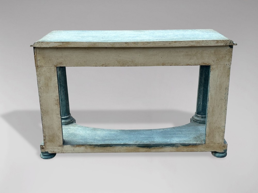 A 19th-century Gothic Revival console table with a distressed teal-green painted finish, carved tracery frieze, and column legs. View VI