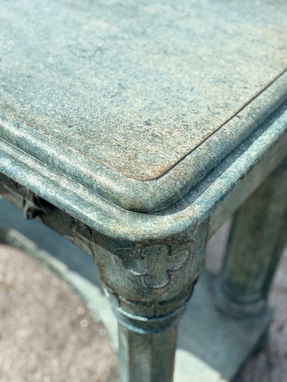 A 19th-century Gothic Revival console table with a distressed teal-green painted finish, carved tracery frieze, and column legs. View VIII