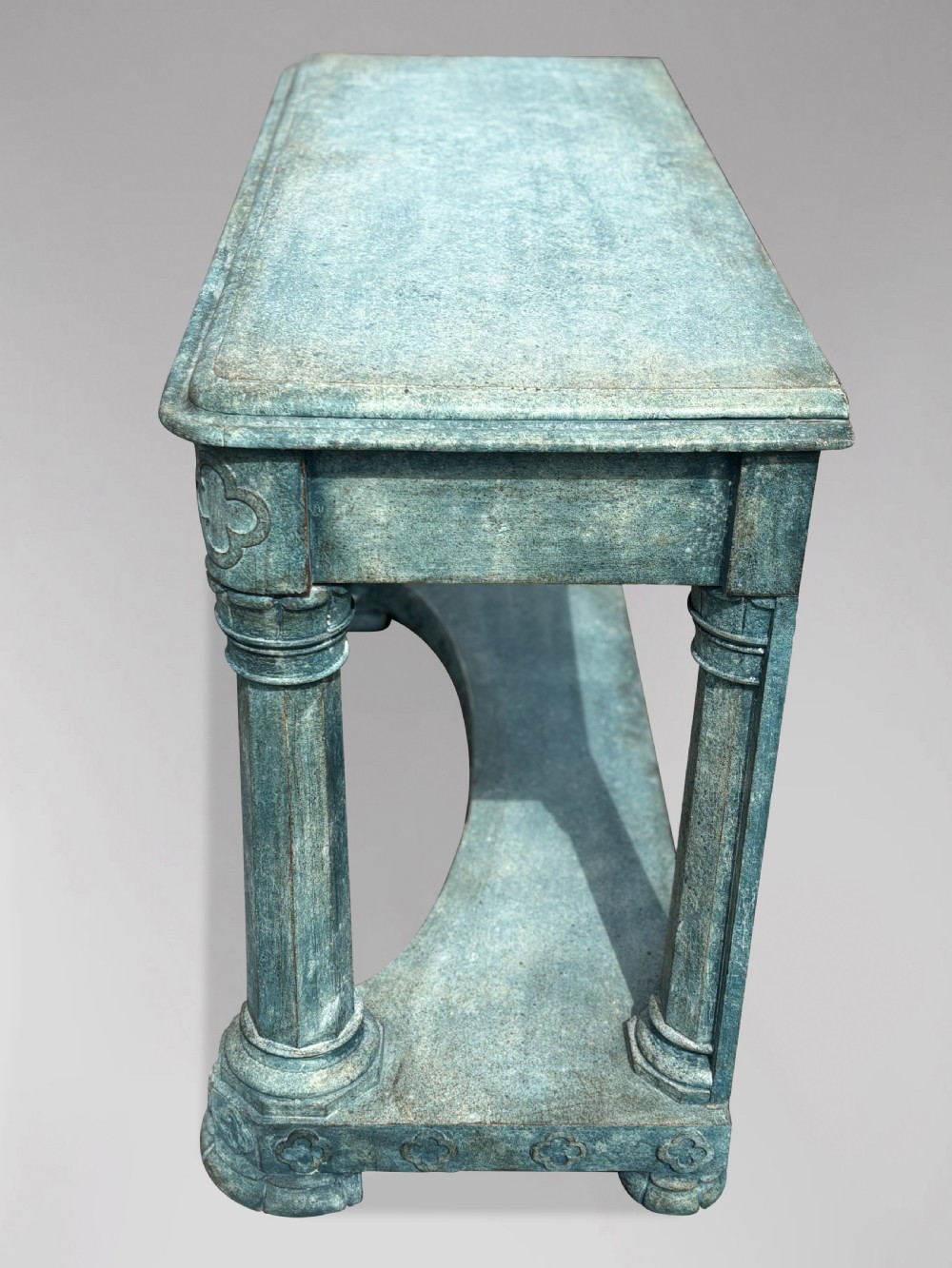 A 19th-century Gothic Revival console table with a distressed teal-green painted finish, carved tracery frieze, and column legs. View X