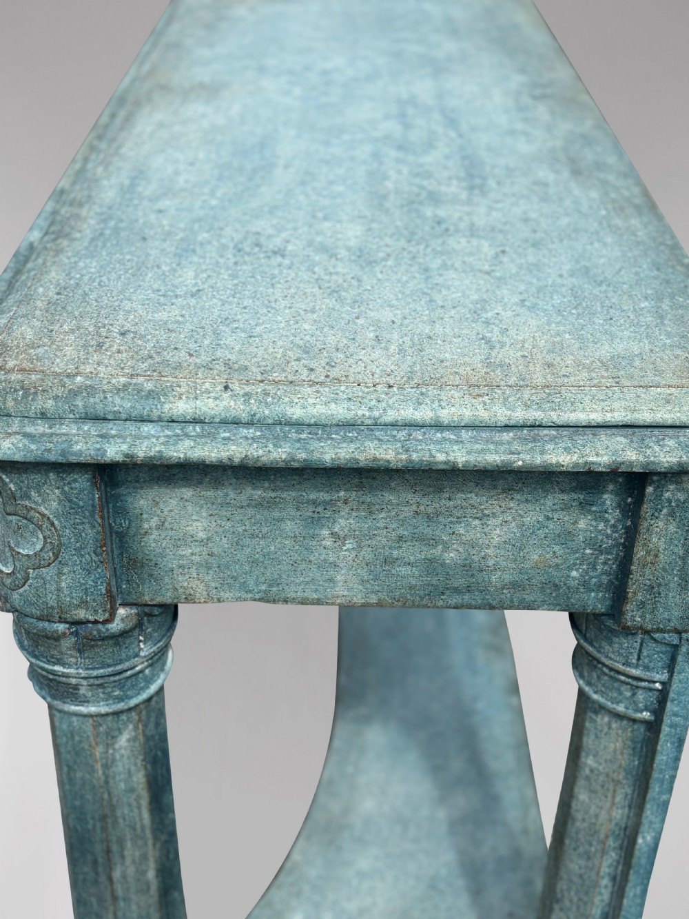 A 19th-century Gothic Revival console table with a distressed teal-green painted finish, carved tracery frieze, and column legs. View XI