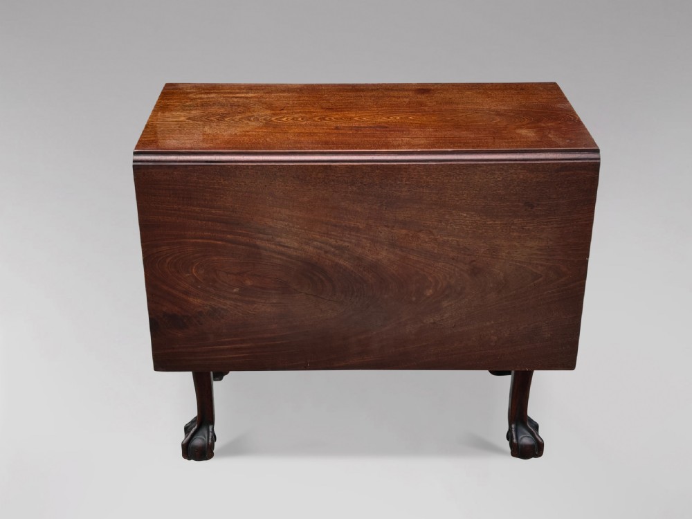 An 18th-century George II mahogany drop-leaf table featuring two hinged leaves, cabriole legs, and carved claw and ball feet. View II