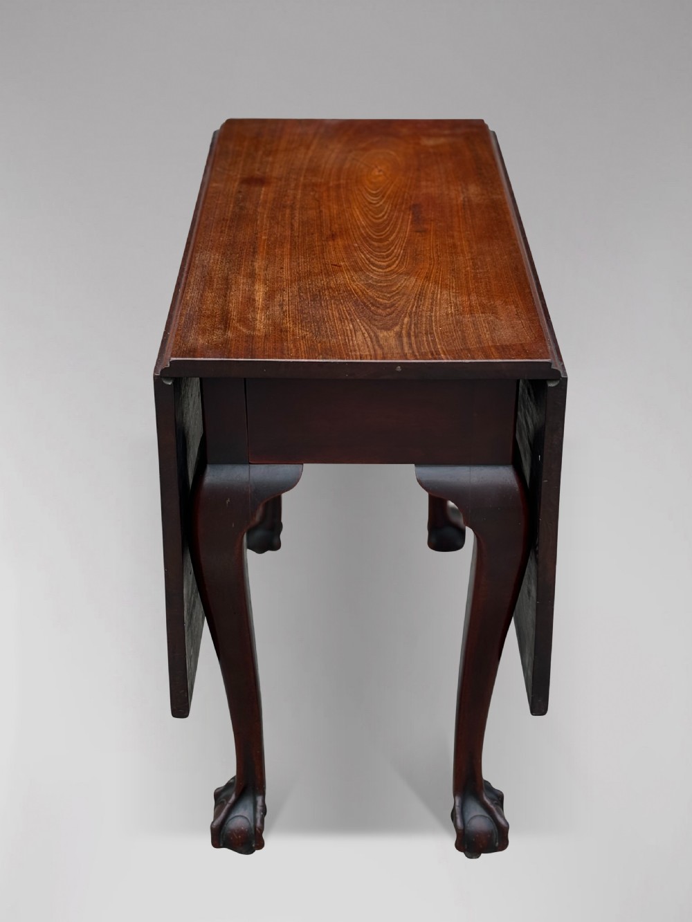 An 18th-century George II mahogany drop-leaf table featuring two hinged leaves, cabriole legs, and carved claw and ball feet. View III