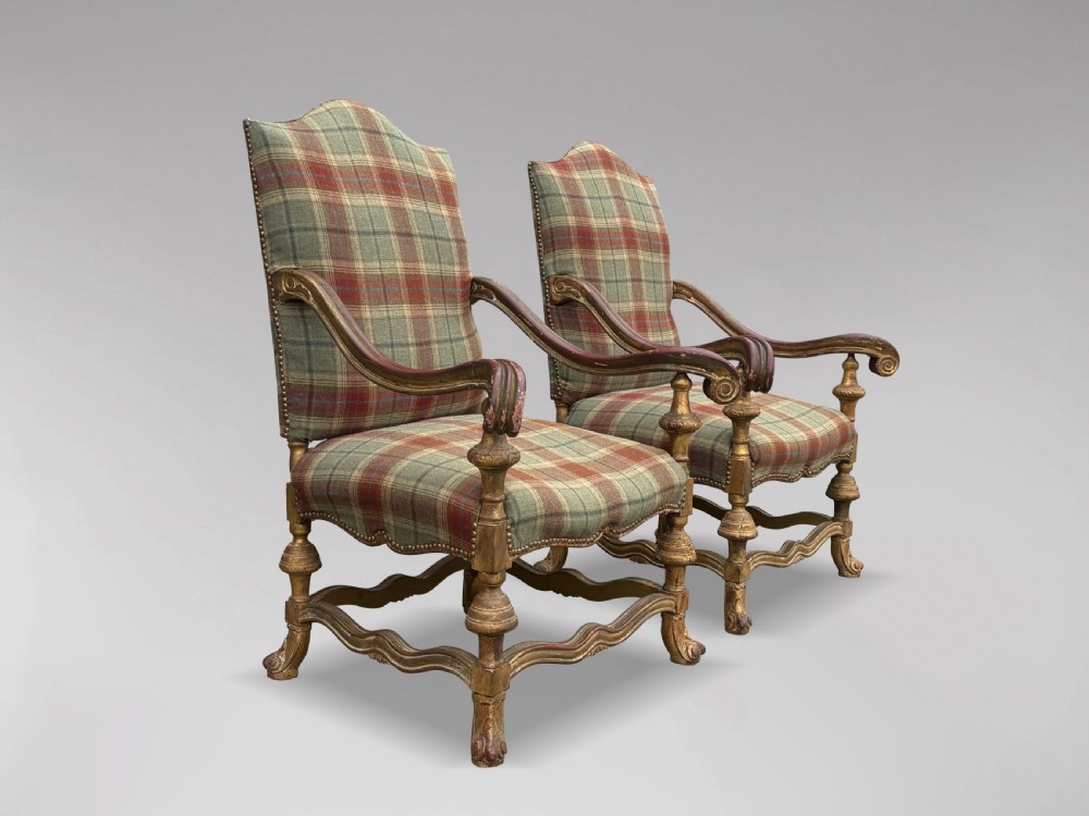 A pair of 19th-century French giltwood throne armchairs upholstered in green and red tartan plaid fabric with carved scroll arms. View II