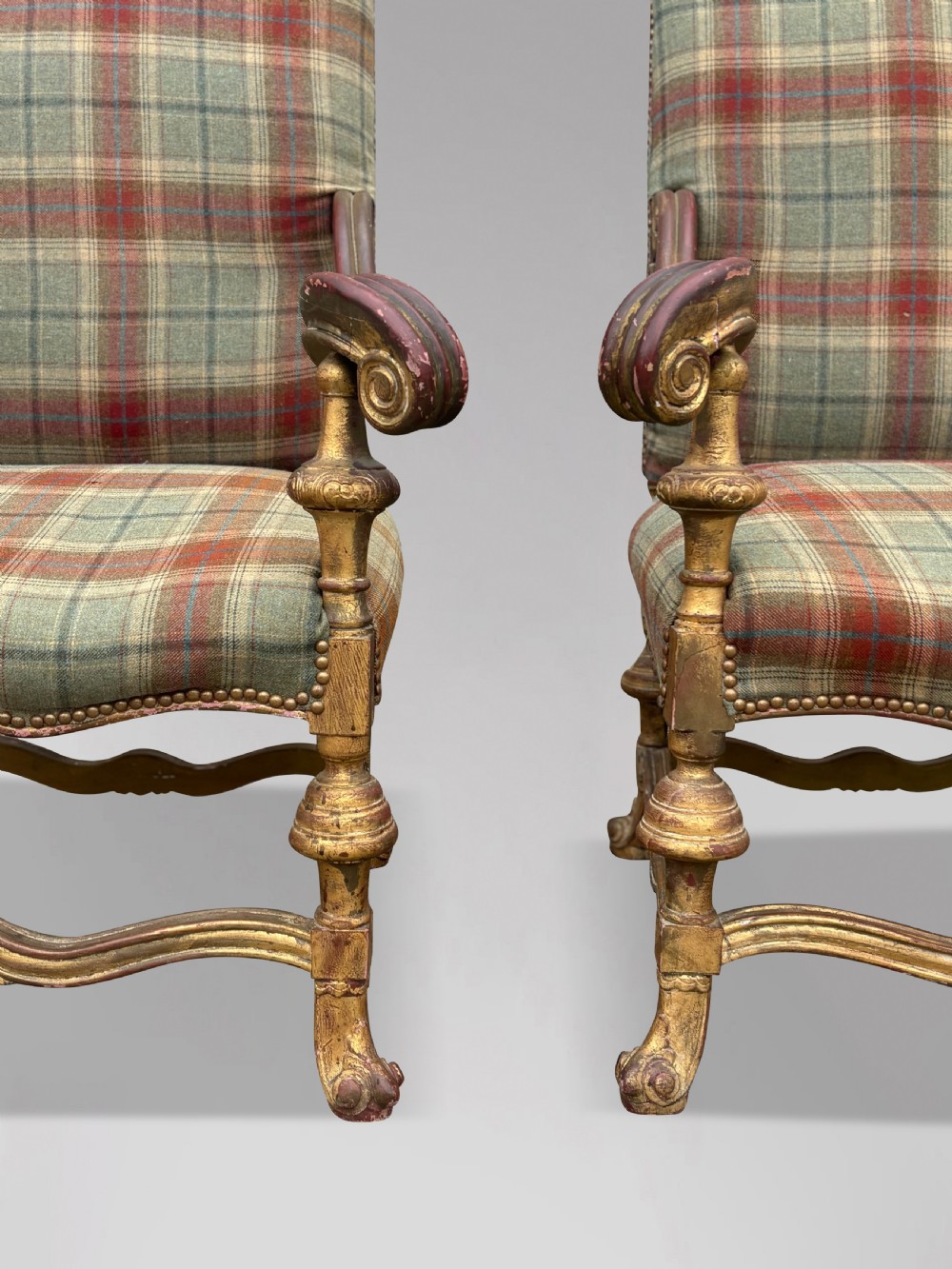 A pair of 19th-century French giltwood throne armchairs upholstered in green and red tartan plaid fabric with carved scroll arms. View III