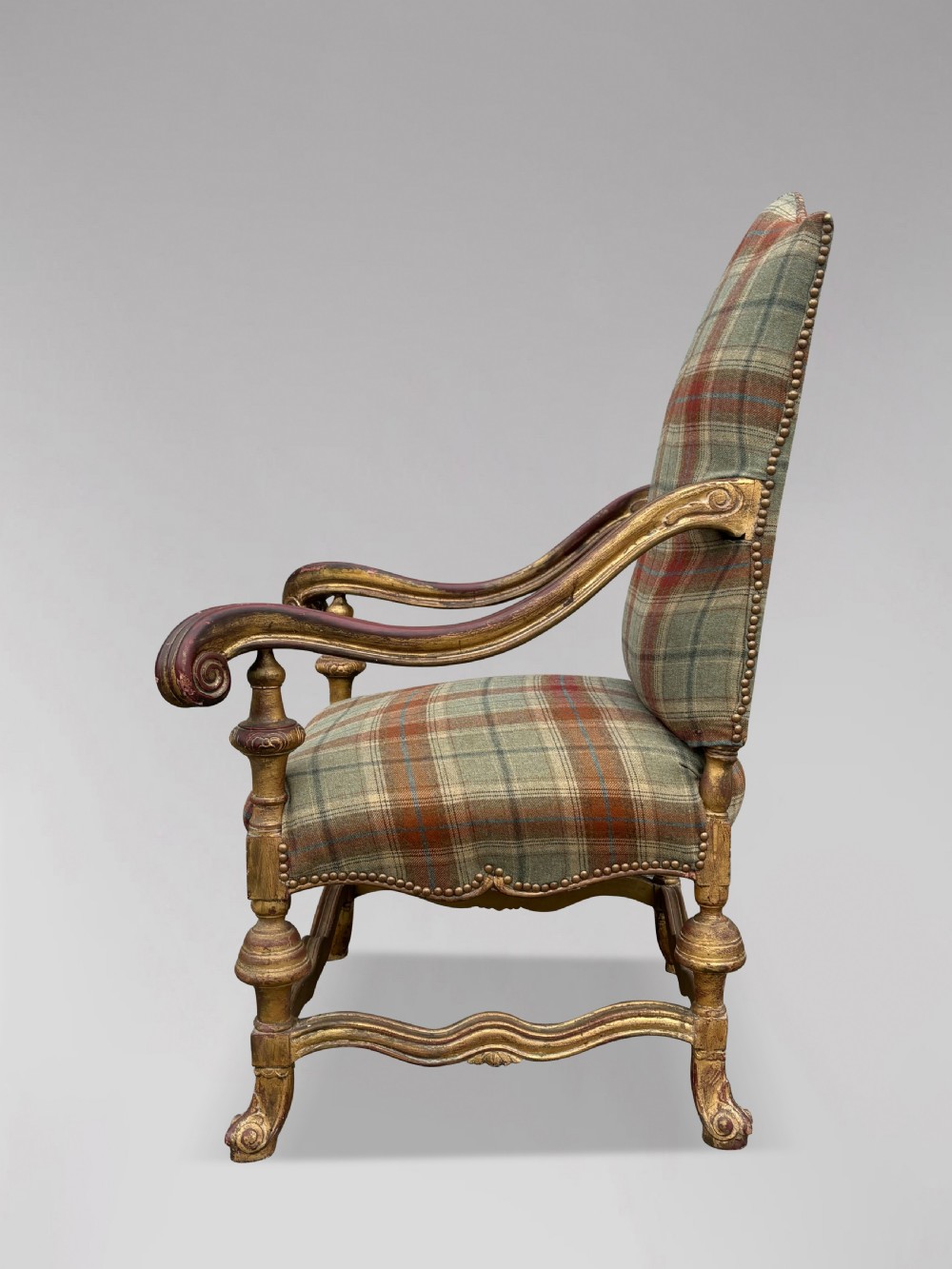 A pair of 19th-century French giltwood throne armchairs upholstered in green and red tartan plaid fabric with carved scroll arms. View VII