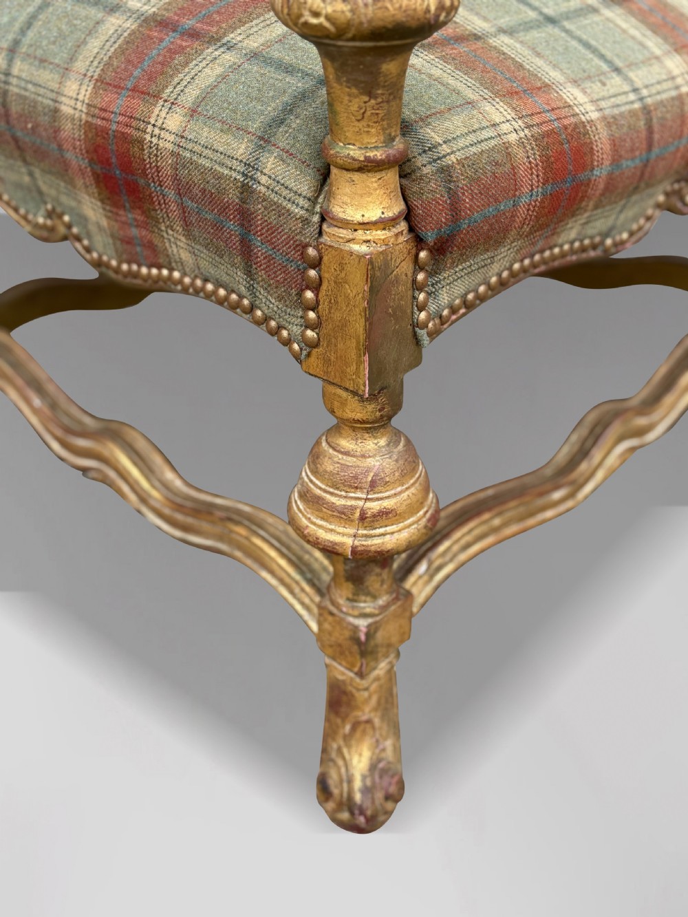 A pair of 19th-century French giltwood throne armchairs upholstered in green and red tartan plaid fabric with carved scroll arms. View IX