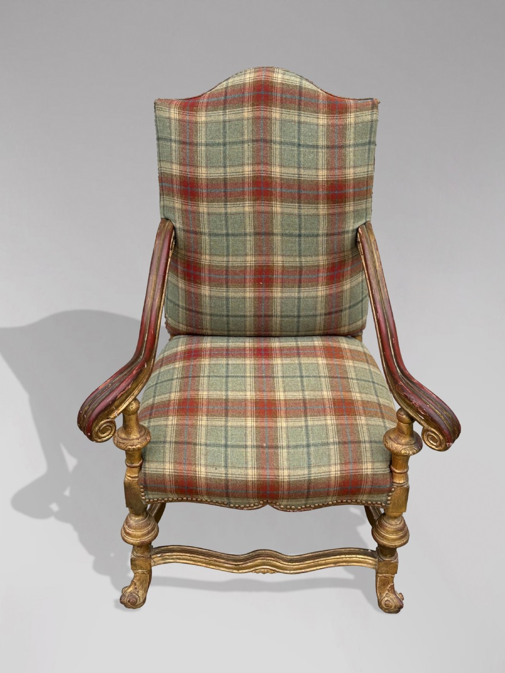 A pair of 19th-century French giltwood throne armchairs upholstered in green and red tartan plaid fabric with carved scroll arms. View X