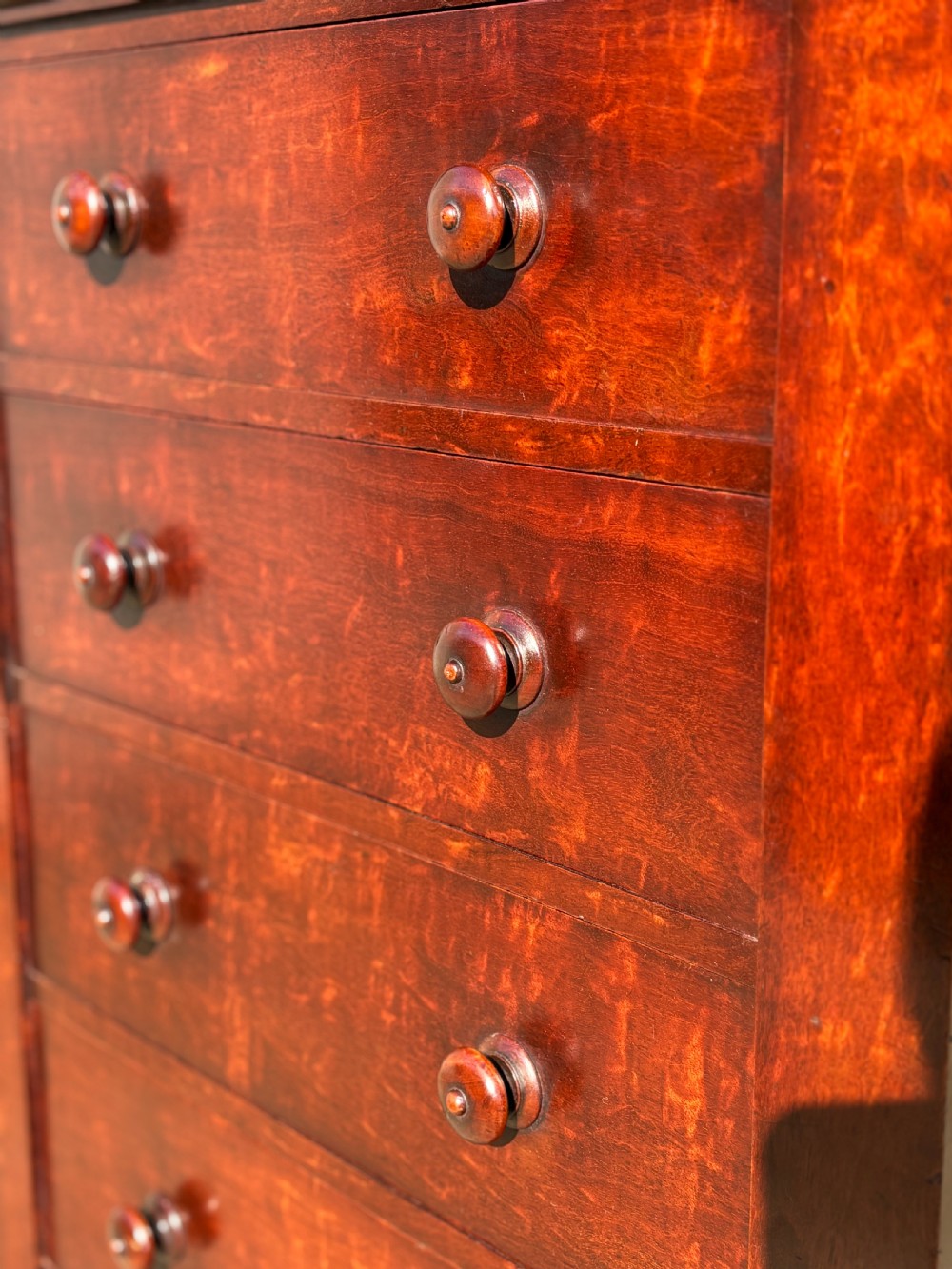 A tall 19th-century Georgian mahogany Wellington chest featuring seven graduated drawers with turned knobs and a hinged side locking flap. View VIII
