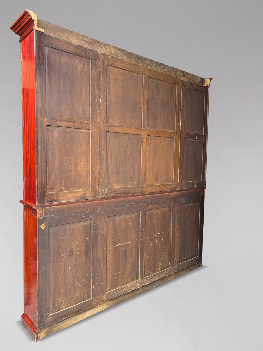 A large mid-nineteenth-century mahogany breakfront library bookcase featuring glazed upper doors, panelled lower cupboard doors, and a stepped moulded cornice. View III