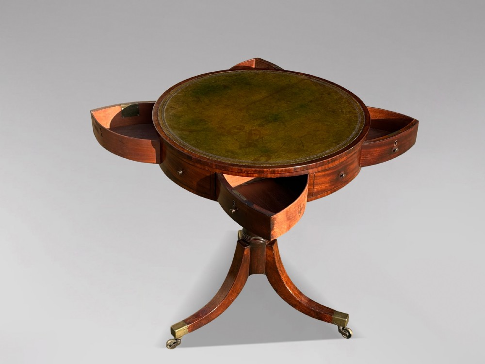 An 18th-century George III mahogany drum table with a circular green leather top, frieze drawers, turned pedestal, and splayed legs with brass castors. View III