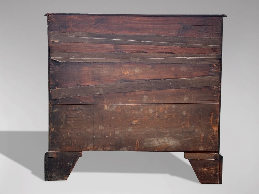An 18th-century George III mahogany chest of drawers featuring two short over three long graduated drawers with brass swan-neck handles and bracket feet. View IV