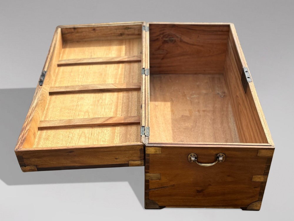 A rectangular 19th-century camphor wood campaign trunk featuring flush brass corner brackets, recessed side handles, and a central brass lock plate. View IV