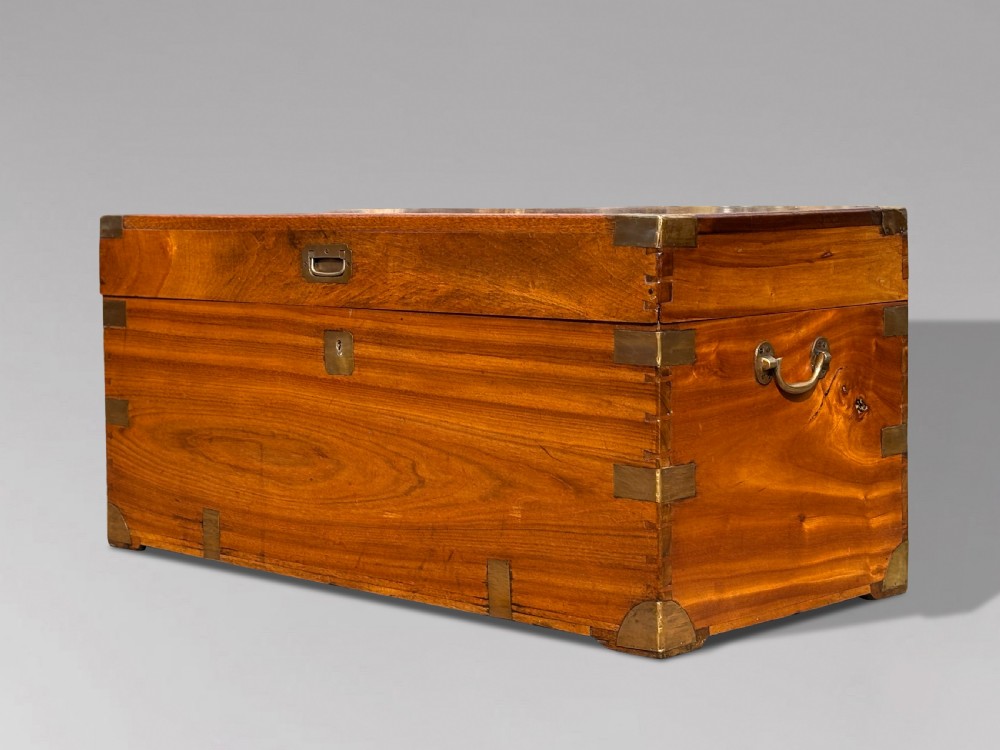 A rectangular 19th-century camphor wood campaign trunk featuring flush brass corner brackets, recessed side handles, and a central brass lock plate. View VIII