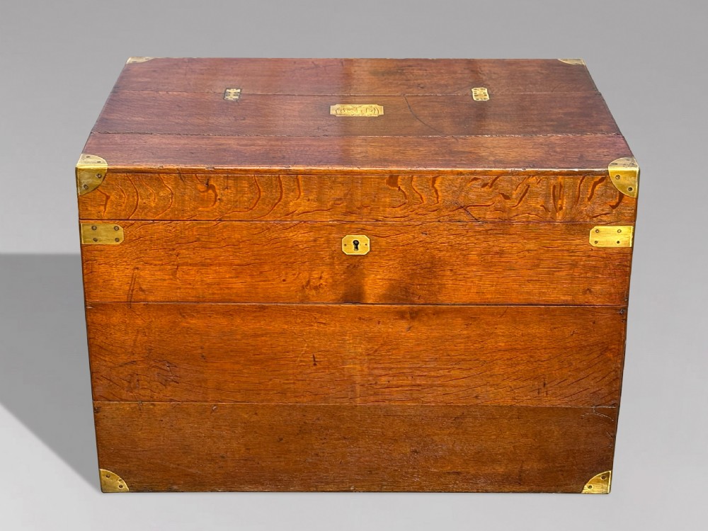 A large rectangular 19th-century oak travelling trunk featuring brass corner mounts, drop side handles, and an inlaid lid cartouche. View II