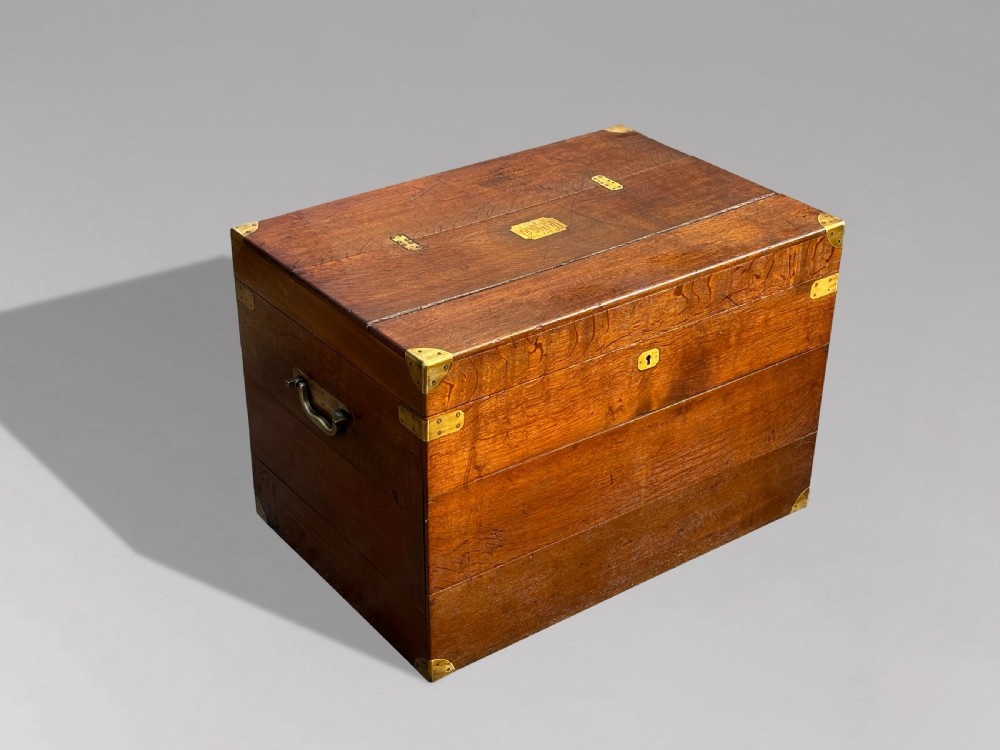 A large rectangular 19th-century oak travelling trunk featuring brass corner mounts, drop side handles, and an inlaid lid cartouche. View VII