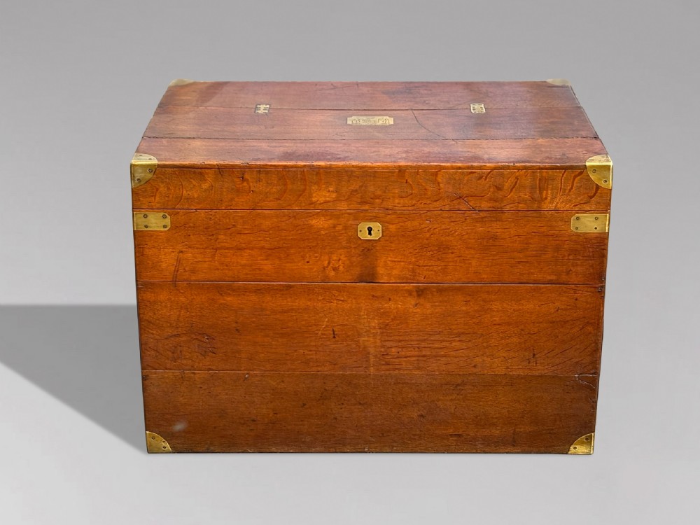 A large rectangular 19th-century oak travelling trunk featuring brass corner mounts, drop side handles, and an inlaid lid cartouche. View IX