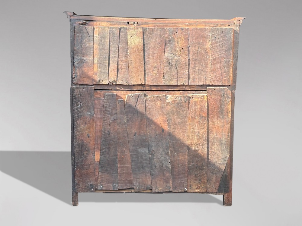 An 18th-century dark elm court cupboard with carved date inscription, panelled doors, brass escutcheons, and iron hinges. View VII