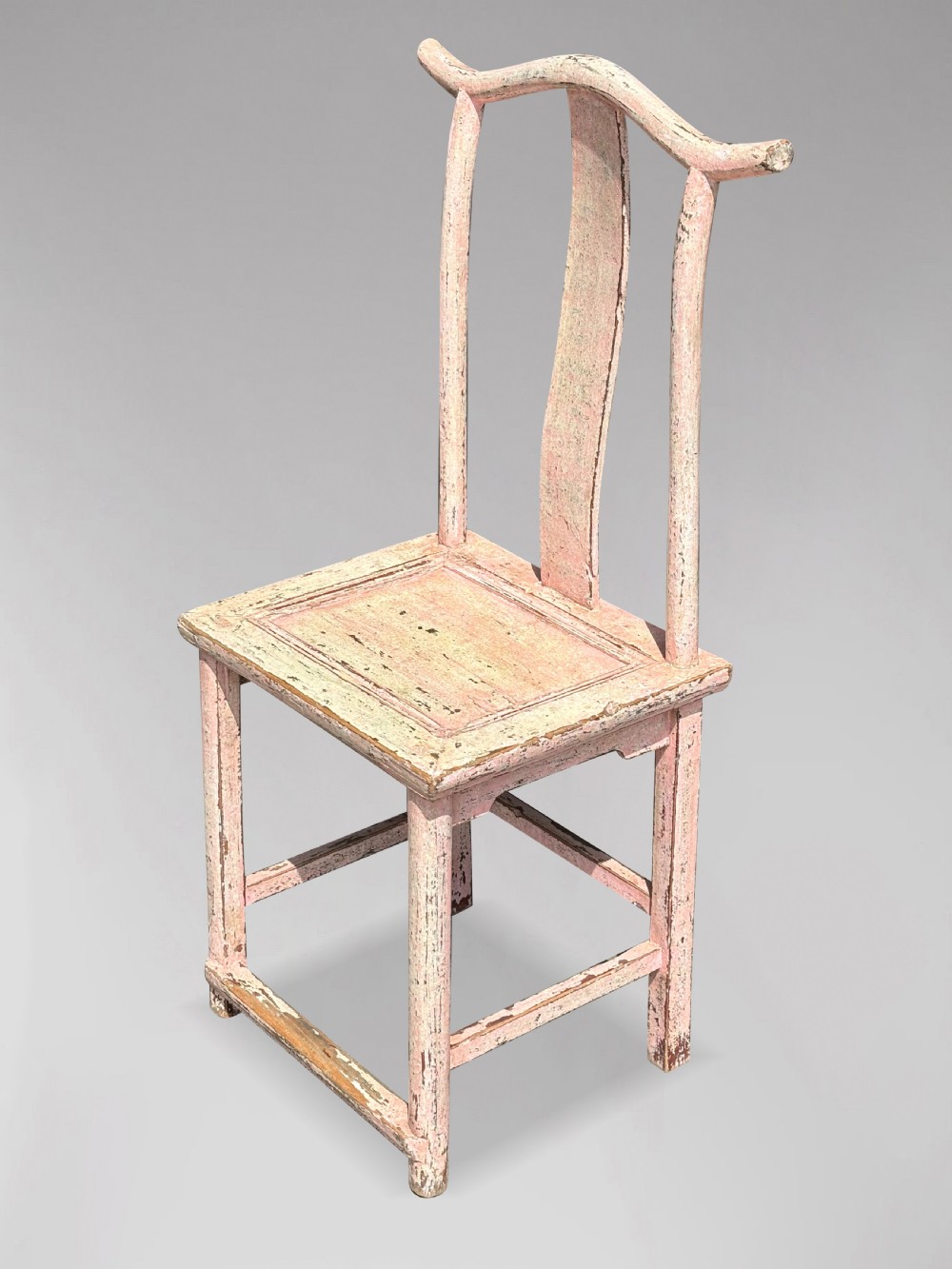A pair of 19th-century Chinese yoke-back side chairs featuring a distressed pale pink painted finish, curved top rails, and central vertical back splats. View V