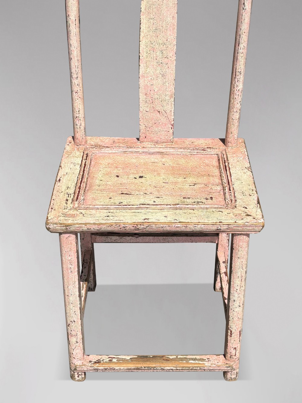 A pair of 19th-century Chinese yoke-back side chairs featuring a distressed pale pink painted finish, curved top rails, and central vertical back splats. View VII
