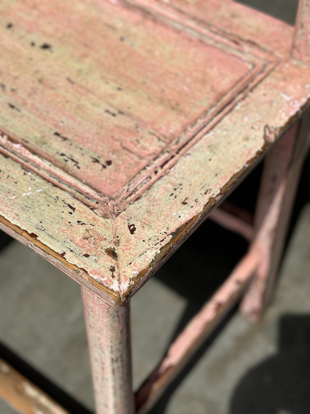 A pair of 19th-century Chinese yoke-back side chairs featuring a distressed pale pink painted finish, curved top rails, and central vertical back splats. View IX