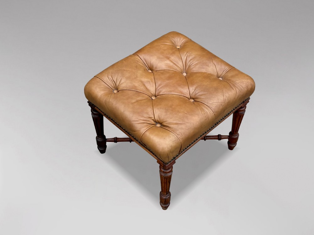 A 19th-century Regency period stool featuring a button-tufted tan leather seat with brass stud trimming, supported by turned fluted rosewood legs and turned stretchers. View II