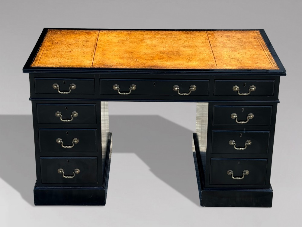 A 19th-century ebonised mahogany pedestal desk featuring a tan tooled leather inset top and brass swan-neck handles. View II