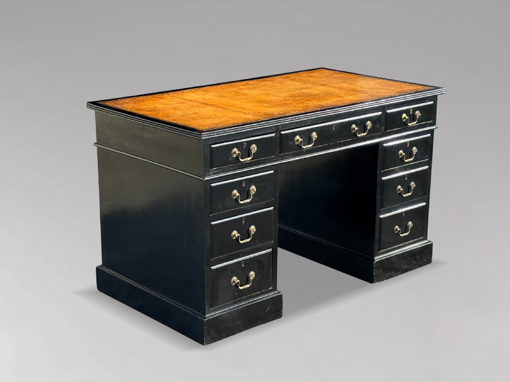 A 19th-century ebonised mahogany pedestal desk featuring a tan tooled leather inset top and brass swan-neck handles. View VII