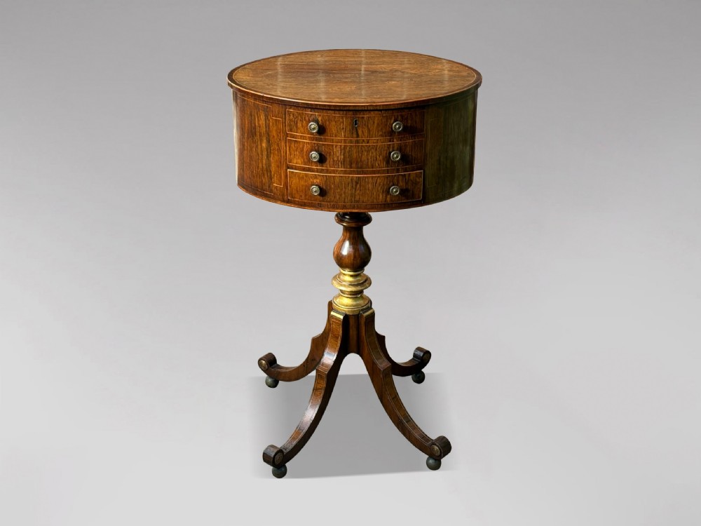 A 19th-century Regency rosewood circular work table featuring drawer fronts with brass knobs, a turned central stem, and a tripod base on ball feet. View II