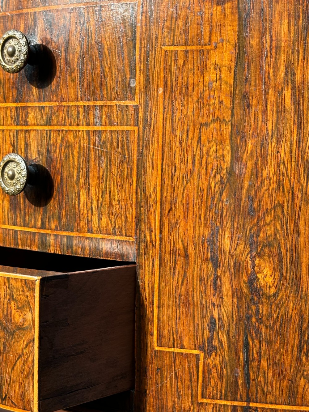 A 19th-century Regency rosewood circular work table featuring drawer fronts with brass knobs, a turned central stem, and a tripod base on ball feet. View VII