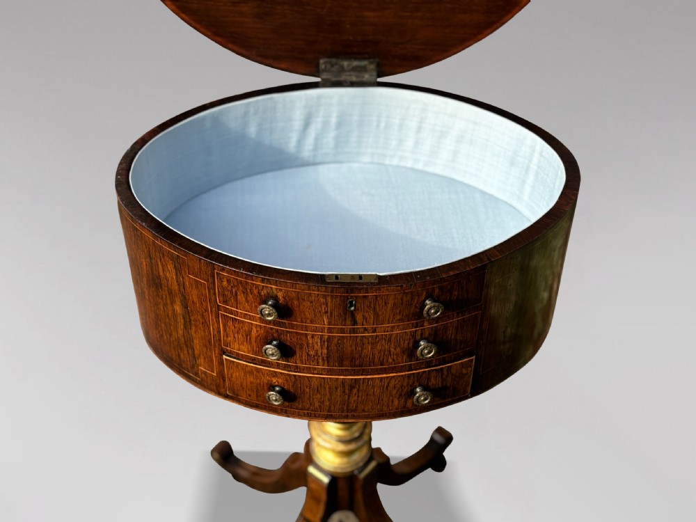 A 19th-century Regency rosewood circular work table featuring drawer fronts with brass knobs, a turned central stem, and a tripod base on ball feet. View XIII
